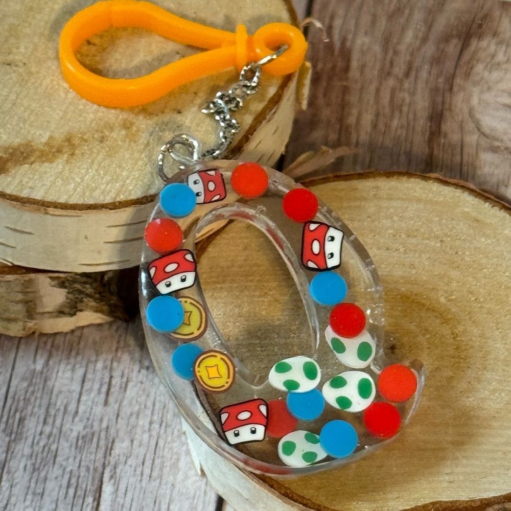 Letter Q with video game inspired charms newly made.